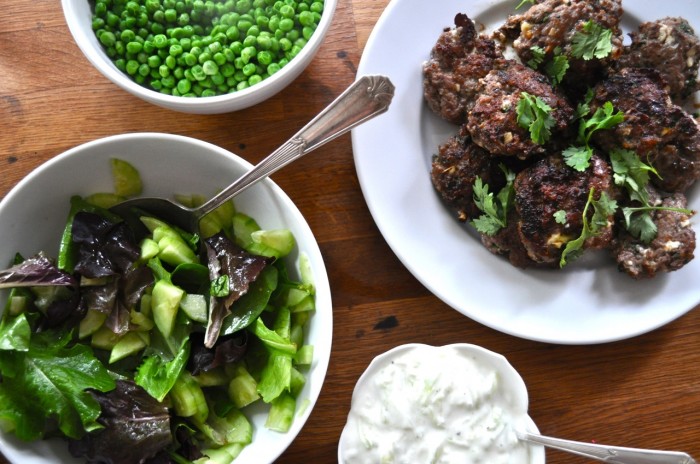 lamb and feta burgers, tzatziki, cucumber salad, and peas