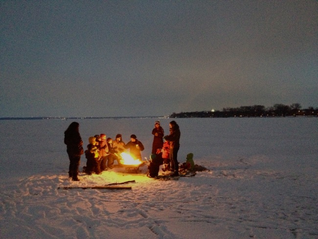 roasting marshmallows on a frozen lake